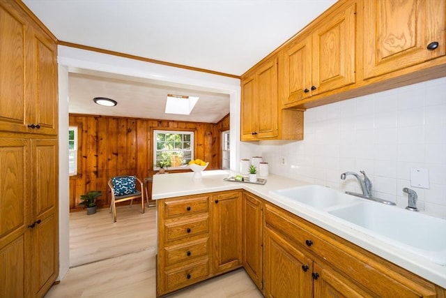 6 Macarthur Rd, Natick, MA 01760 - kitchen with a skylight, brown cabinetry, light countertops, and a peninsula