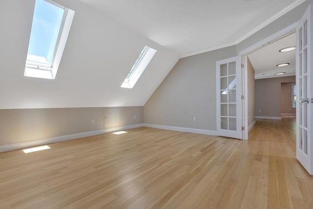 24-26 Bentley St, Boston, MA 02135 - bonus room with a skylight, light wood finished floors, french doors, and vaulted ceiling