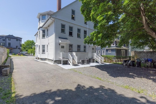 24-26 Bentley St, Boston, MA 02135 - back of property featuring a chimney and a residential view