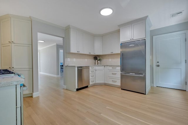 24-26 Bentley St, Boston, MA 02135 - kitchen with appliances with stainless steel finishes, crown molding, tasteful backsplash, light wood finished floors, and light stone countertops