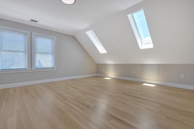 24-26 Bentley St, Boston, MA 02135 - bonus room featuring a skylight, healthy amount of natural light, light wood-style flooring, and vaulted ceiling