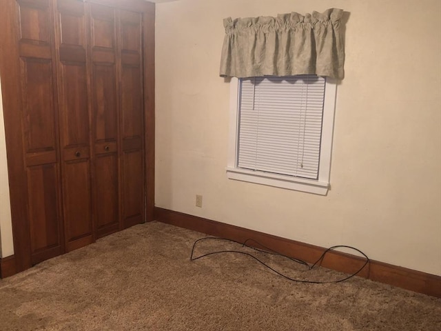 unfurnished bedroom with carpet and a closet