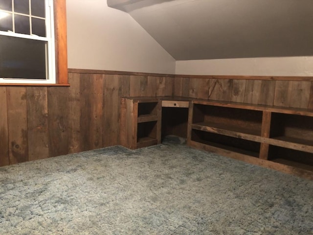 additional living space with carpet flooring and lofted ceiling