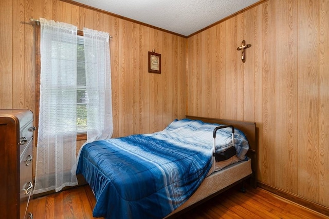 376 N Underwood St, Fall River, MA 02720 - bedroom with multiple windows, wood walls, wood finished floors, crown molding, and a textured ceiling