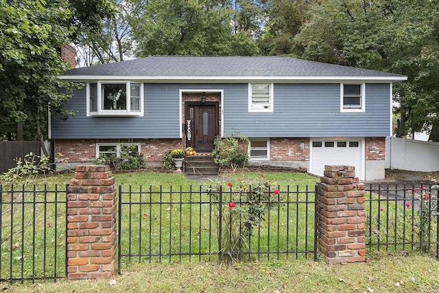 raised ranch featuring a front lawn and a garage