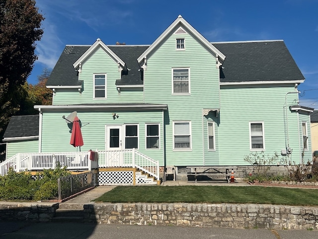 rear view of house with a yard