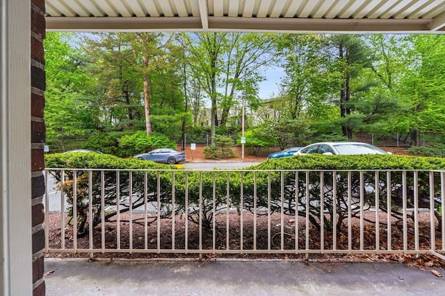 balcony with view of wooded area