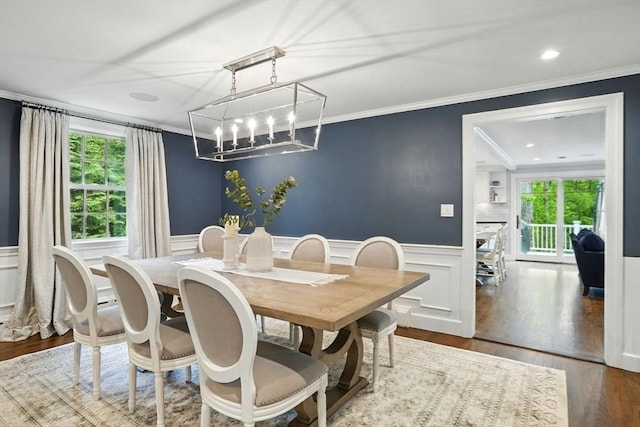 12 Olde Lyme Rd, Winchester, MA 01890 - dining room featuring healthy amount of natural light, crown molding, wainscoting, a decorative wall, and wood finished floors