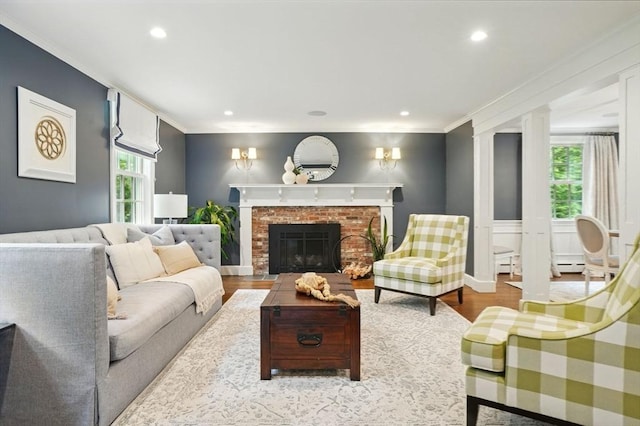 12 Olde Lyme Rd, Winchester, MA 01890 - living area with wood finished floors, ornamental molding, a fireplace, a baseboard radiator, and recessed lighting