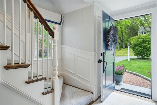 12 Olde Lyme Rd, Winchester, MA 01890 - entryway with stairway, a wainscoted wall, a decorative wall, lofted ceiling, and crown molding