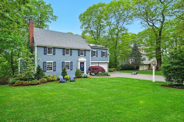 12 Olde Lyme Rd, Winchester, MA 01890 - colonial house featuring a chimney, asphalt driveway, an attached garage, and a front lawn
