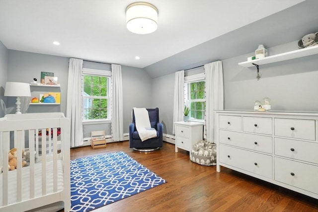 12 Olde Lyme Rd, Winchester, MA 01890 - bedroom featuring wood finished floors, vaulted ceiling, baseboard heating, a crib, and recessed lighting