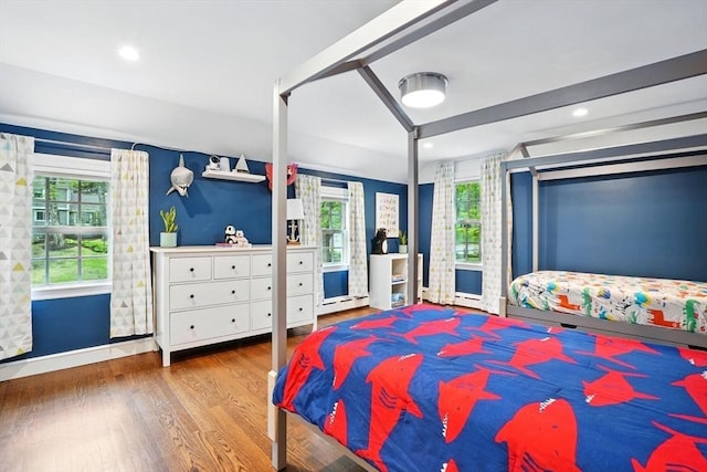 12 Olde Lyme Rd, Winchester, MA 01890 - bedroom with wood finished floors, multiple windows, baseboard heating, baseboards, and recessed lighting