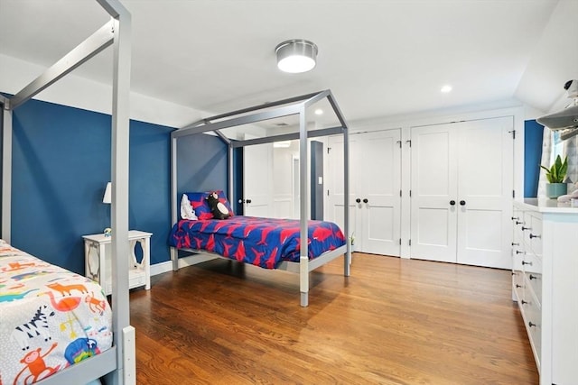 12 Olde Lyme Rd, Winchester, MA 01890 - bedroom with wood finished floors, two closets, recessed lighting, and lofted ceiling