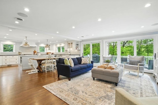 12 Olde Lyme Rd, Winchester, MA 01890 - living area with wood finished floors, crown molding, and recessed lighting