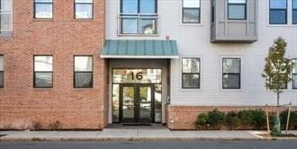 16 Boardman St Unit 204A, Boston, MA 02128 - doorway to property with french doors, brick siding, and a standing seam roof