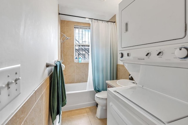 31 Massachusetts Ave Unit 4-4, Boston, MA 02115 - full bathroom with stacked washer / drying machine, toilet, shower / tub combo, tile patterned flooring, and tile walls
