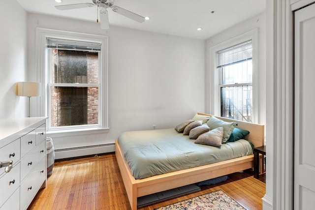 31 Massachusetts Ave Unit 4-4, Boston, MA 02115 - bedroom with a baseboard radiator, light wood finished floors, recessed lighting, and a ceiling fan