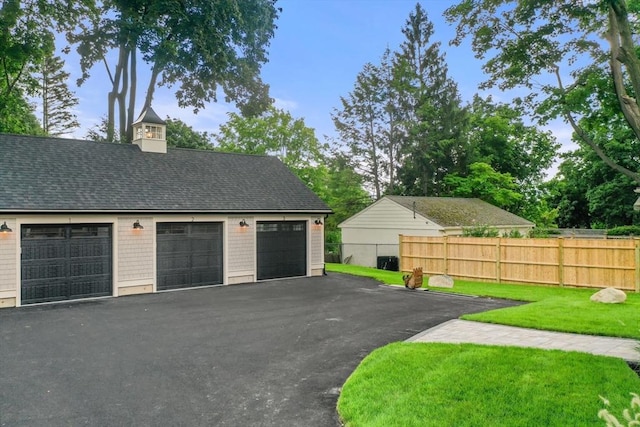 garage featuring a lawn