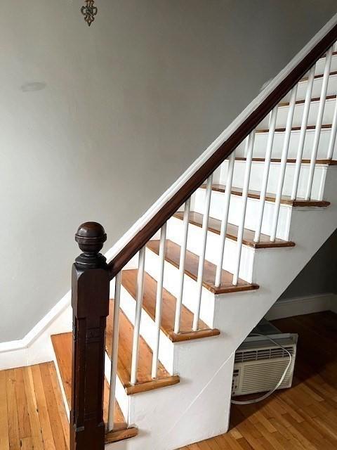 129 3rd St, Lowell, MA 01850 - stairway featuring wood finished floors and baseboards