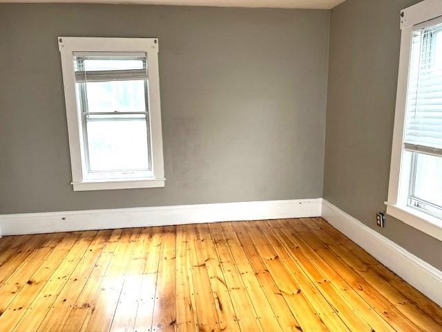 129 3rd St, Lowell, MA 01850 - unfurnished room featuring baseboards and hardwood / wood-style floors