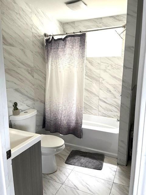 129 3rd St, Lowell, MA 01850 - bathroom featuring toilet, shower / bathtub combination with curtain, vanity, and marble finish floors