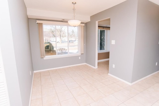 unfurnished dining area featuring light tile patterned flooring and baseboards