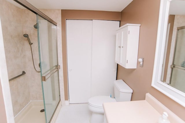 full bath featuring toilet, a stall shower, tile patterned flooring, and vanity