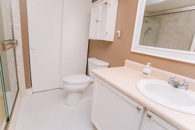 full bath with a shower with shower door, vanity, toilet, and tile patterned floors