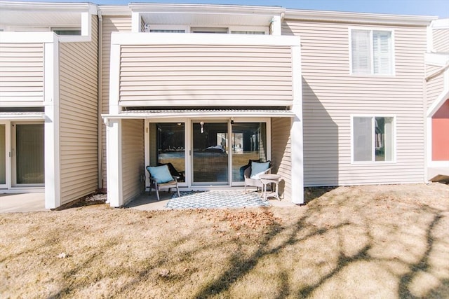 rear view of property with a patio and a balcony