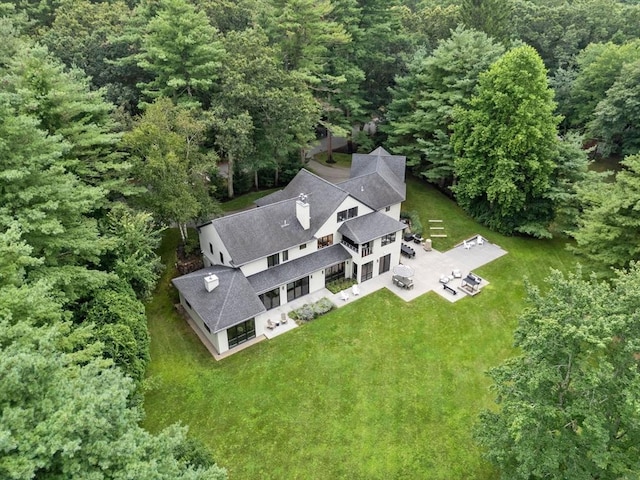 birds eye view of property with a forest view