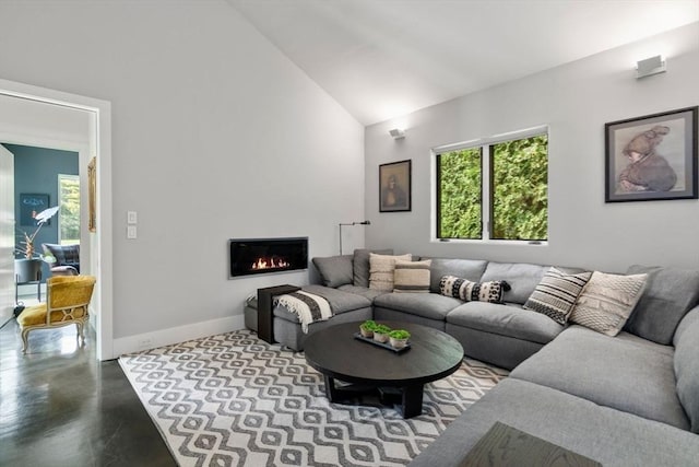 living area with high vaulted ceiling, baseboards, and a lit fireplace