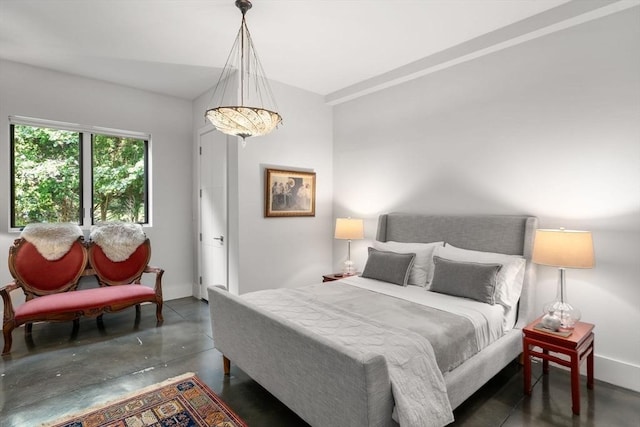 bedroom with baseboards and finished concrete floors