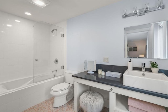 full bathroom with vanity, toilet, and tiled shower / bath combo