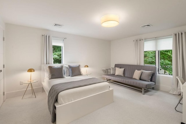 carpeted bedroom with visible vents and baseboards