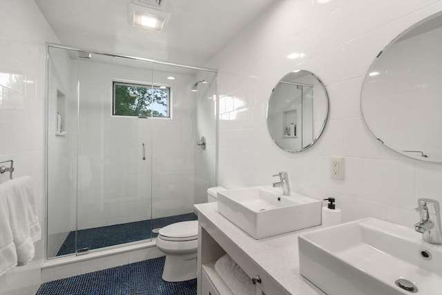 full bath featuring a sink, tile walls, and a shower stall