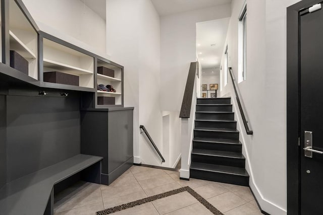 mudroom featuring baseboards and light tile patterned flooring