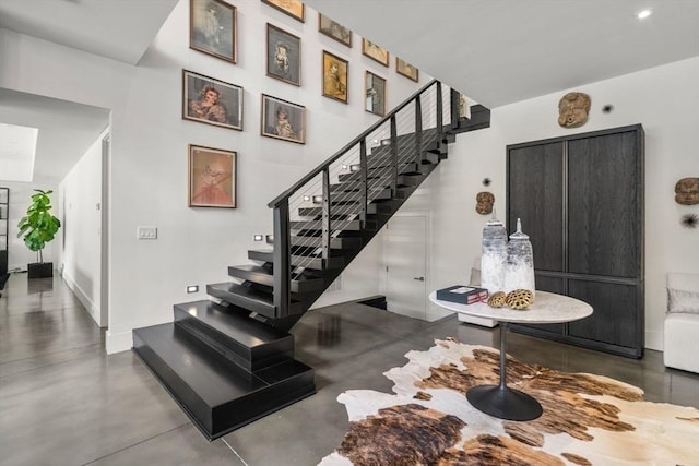 stairway featuring concrete flooring