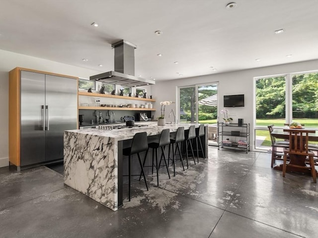 kitchen featuring ventilation hood, concrete flooring, appliances with stainless steel finishes, a large island, and open shelves