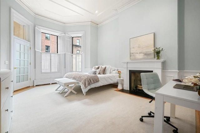 bedroom with crown molding, a fireplace with flush hearth, and an office area