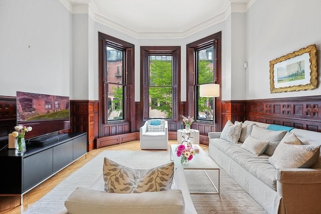 living room with ornamental molding and a wainscoted wall