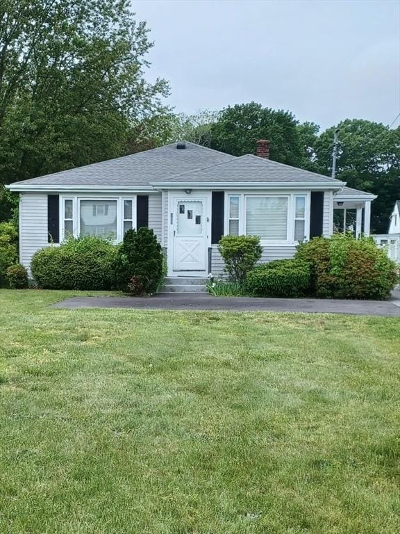 822 N Eastern Ave, Fall River, MA 02720 - view of front of home featuring a chimney, a front lawn, and roof with shingles