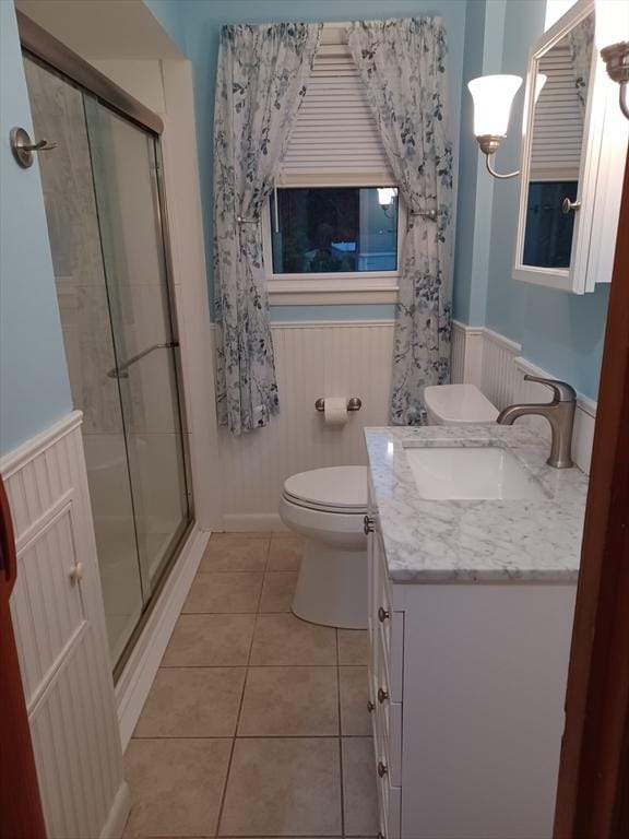 822 N Eastern Ave, Fall River, MA 02720 - full bath featuring wainscoting, a stall shower, vanity, tile patterned floors, and toilet
