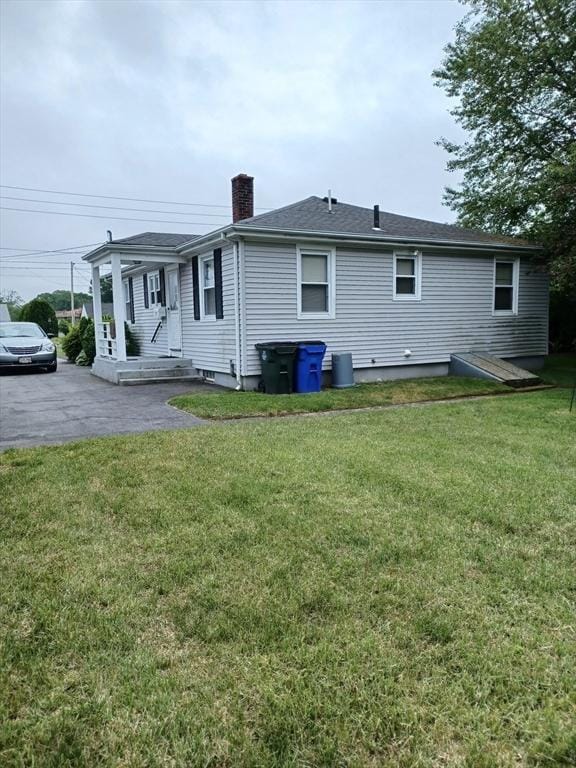 822 N Eastern Ave, Fall River, MA 02720 - rear view of house with a chimney and a yard