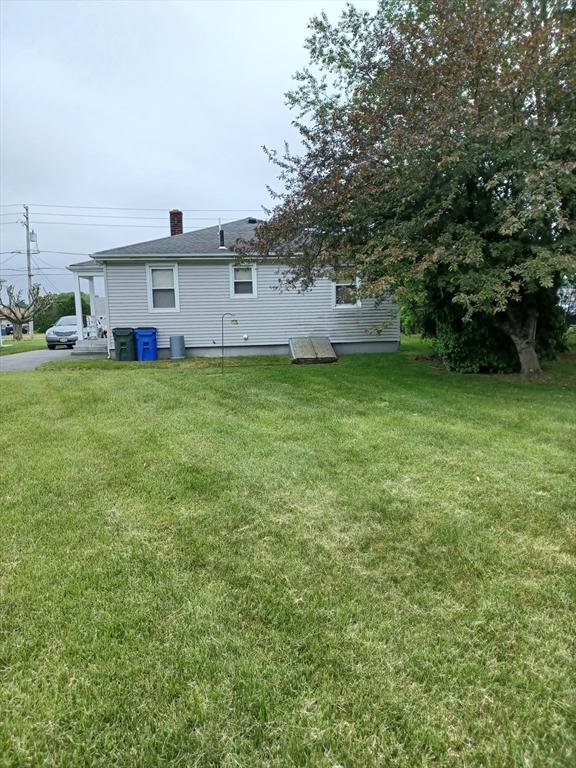 822 N Eastern Ave, Fall River, MA 02720 - back of property with a lawn and a chimney
