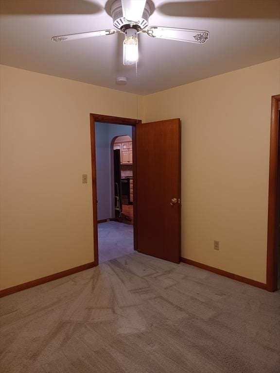 822 N Eastern Ave, Fall River, MA 02720 - spare room with arched walkways, light carpet, a ceiling fan, and baseboards