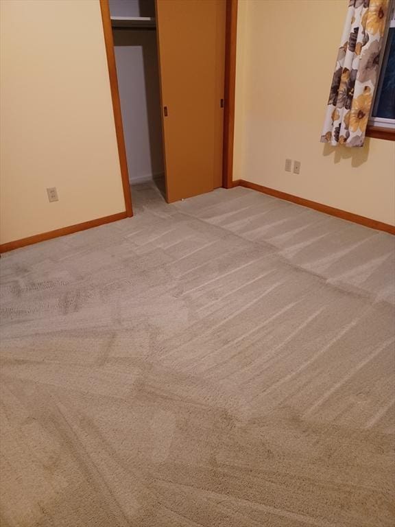 822 N Eastern Ave, Fall River, MA 02720 - unfurnished bedroom with light colored carpet, baseboards, and a closet