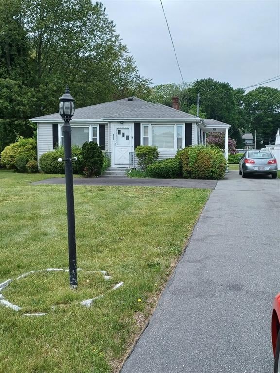 822 N Eastern Ave, Fall River, MA 02720 - view of front of home with a chimney and a front yard