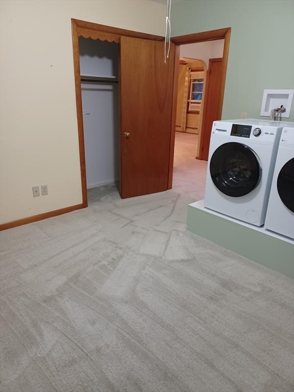 822 N Eastern Ave, Fall River, MA 02720 - laundry area featuring light colored carpet, washing machine and clothes dryer, arched walkways, and baseboards
