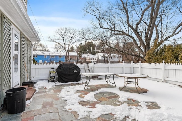 snow covered patio with grilling area